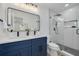 Modern bathroom featuring a double vanity, glass shower, and sleek fixtures at 7414 Van Dyke Rd, Odessa, FL 33556