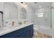 Stylish bathroom featuring double sinks, gold fixtures, and glass-enclosed shower at 7414 Van Dyke Rd, Odessa, FL 33556