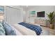 Bright bedroom with white closet doors, a dresser, and calming beach-themed decor at 7414 Van Dyke Rd, Odessa, FL 33556