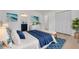 Tranquil bedroom with ocean-themed decor, a comfortable bed, and closet at 7414 Van Dyke Rd, Odessa, FL 33556