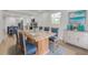 Bright dining area with a modern table, chairs, and view into the kitchen at 7414 Van Dyke Rd, Odessa, FL 33556