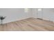 Bright, airy room featuring light wood floors, white walls, and a door with window at 7414 Van Dyke Rd, Odessa, FL 33556