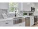 Bright kitchen with stainless steel appliances, white countertops, and updated fixtures at 7414 Van Dyke Rd, Odessa, FL 33556