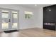 Living room with modern fireplace, light hardwood floors, and outdoor access at 7414 Van Dyke Rd, Odessa, FL 33556