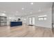 Open-concept living space with hardwood floors and modern kitchen island at 7414 Van Dyke Rd, Odessa, FL 33556