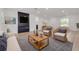 Bright living room featuring a contemporary fireplace, seating, and natural light at 7414 Van Dyke Rd, Odessa, FL 33556