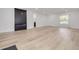 Bright and spacious living area with a modern fireplace and hardwood flooring at 7414 Van Dyke Rd, Odessa, FL 33556