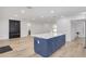 Open concept living space with kitchen island, sleek fireplace, and modern flooring at 7414 Van Dyke Rd, Odessa, FL 33556