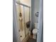 Bathroom features standing shower, toilet, with storage and modern fixtures at 189 Colonial Blvd # 24, Palm Harbor, FL 34684