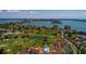 Stunning aerial view of a waterfront community with a golf course, pool, and nearby bridge at 6011 Bahia Del Mar Blvd # 150, St Petersburg, FL 33715