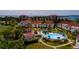 An aerial view of a condo complex featuring a pool, golf course, and bay views at 6011 Bahia Del Mar Blvd # 150, St Petersburg, FL 33715