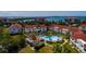 Aerial view of a condo building in a community with a pool, overlooking the water and bridge at 6011 Bahia Del Mar Blvd # 150, St Petersburg, FL 33715