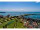 Aerial view of a waterfront community with a golf course, pool, and bridge at 6011 Bahia Del Mar Blvd # 150, St Petersburg, FL 33715