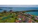Aerial view of a Florida condo community nestled between a golf course, bay, and bridge at 6011 Bahia Del Mar Blvd # 150, St Petersburg, FL 33715
