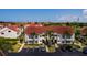 Aerial view of a two-story condo building with red tile roof and parking lot at 6011 Bahia Del Mar Blvd # 150, St Petersburg, FL 33715