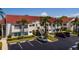 Exterior view of a multi-story residential building with parking spaces and palm trees at 6011 Bahia Del Mar Blvd # 150, St Petersburg, FL 33715