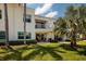 Exterior view of the home showcasing the lush green landscaping and patio at 6011 Bahia Del Mar Blvd # 150, St Petersburg, FL 33715