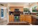 Compact kitchen featuring light wood cabinets, stainless steel appliances, and granite countertops at 6011 Bahia Del Mar Blvd # 150, St Petersburg, FL 33715