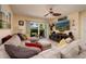 Living room with comfortable seating, large TV, and sliding glass doors to a patio at 6011 Bahia Del Mar Blvd # 150, St Petersburg, FL 33715