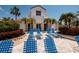Community pool area with blue lounge chairs and palm trees at 6011 Bahia Del Mar Blvd # 150, St Petersburg, FL 33715