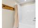 Bathroom with tub shower and beige curtain at 2619 Redford Way, Wesley Chapel, FL 33544