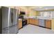 Modern kitchen with stainless steel appliances and light wood cabinets at 2619 Redford Way, Wesley Chapel, FL 33544