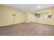 Spacious living area with wood-look floors and views into the kitchen at 2619 Redford Way, Wesley Chapel, FL 33544