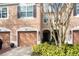 Townhouse exterior featuring a two-car garage and landscaping at 2619 Redford Way, Wesley Chapel, FL 33544