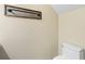 Clean bathroom with a toilet and a wood framed mirror at 2619 Redford Way, Wesley Chapel, FL 33544