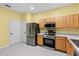 Kitchen featuring stainless steel appliances and wood cabinets at 2619 Redford Way, Wesley Chapel, FL 33544