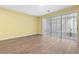 Living room with wood-look floors and access to a screened patio at 2619 Redford Way, Wesley Chapel, FL 33544