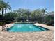 Community pool with lounge chairs and surrounding patio at 2619 Redford Way, Wesley Chapel, FL 33544