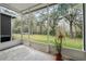 Spacious screened patio with a view of the backyard and trees at 2619 Redford Way, Wesley Chapel, FL 33544
