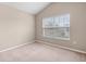 Simple bedroom with neutral walls, carpet, and a large window at 2619 Redford Way, Wesley Chapel, FL 33544