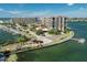 Aerial view of waterfront community with multiple buildings, pool, and boat docks at 1 Key Capri # 104E, Treasure Island, FL 33706