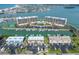 Stunning aerial view of the property with waterfront condos, a marina, and beautiful blue waters at 1 Key Capri # 104E, Treasure Island, FL 33706