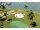 Scenic community area with shuffleboard, putting green, picnic tables, and palm trees, offering outdoor recreation at 1 Key Capri # 104E, Treasure Island, FL 33706