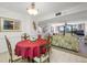 Cozy dining room featuring a round table with a red tablecloth and seating for four near the living room at 1 Key Capri # 104E, Treasure Island, FL 33706