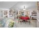 Cozy dining room featuring a round table with a red tablecloth and seating for four in an open floor plan at 1 Key Capri # 104E, Treasure Island, FL 33706