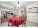 Cozy dining room featuring a round table with a red tablecloth and seating for four near the living room at 1 Key Capri # 104E, Treasure Island, FL 33706