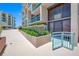 View of a condo with a balcony showcasing the exterior and landscaping at 1 Key Capri # 104E, Treasure Island, FL 33706