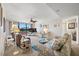 Cozy living room with ceiling fan, floral sofa, and sliding glass doors leading to the outdoor balcony at 1 Key Capri # 104E, Treasure Island, FL 33706