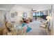 Relaxing living room with comfortable sofas, large windows, and access to balcony at 1 Key Capri # 104E, Treasure Island, FL 33706