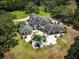 Aerial view of the home and grounds showcasing the surrounding greenery and estate at 550 E East Lake N Rd, Tarpon Springs, FL 34688