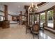 Breakfast area with a round table and chairs overlooking pool at 550 E East Lake N Rd, Tarpon Springs, FL 34688