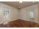 Hallway with hardwood floors, decorative wallpaper and trim, connecting various rooms in the home at 550 E East Lake N Rd, Tarpon Springs, FL 34688