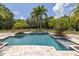 Inviting pool area with multiple features and lush landscaping at 550 E East Lake N Rd, Tarpon Springs, FL 34688