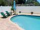 Refreshing pool area with lounge chairs and umbrella at 1826 58Th S St, Gulfport, FL 33707
