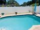Relaxing kidney-shaped pool with patio and fence at 1826 58Th S St, Gulfport, FL 33707
