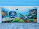 Garage door features a vibrant ocean mural, showcasing marine life at 1826 58Th S St, Gulfport, FL 33707